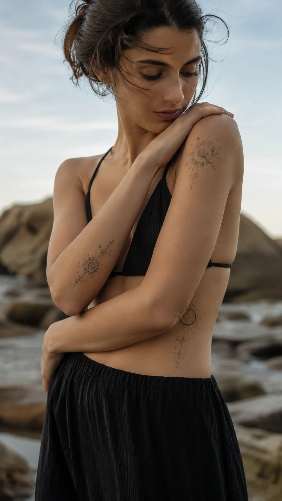 Caderno com esboços de tatuagens astrológicas em estilo minimalista.